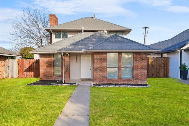 a front view of a house with a yard table and chairs