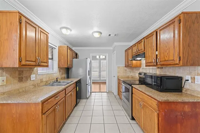 a kitchen with stainless steel appliances granite countertop a sink stove and cabinets