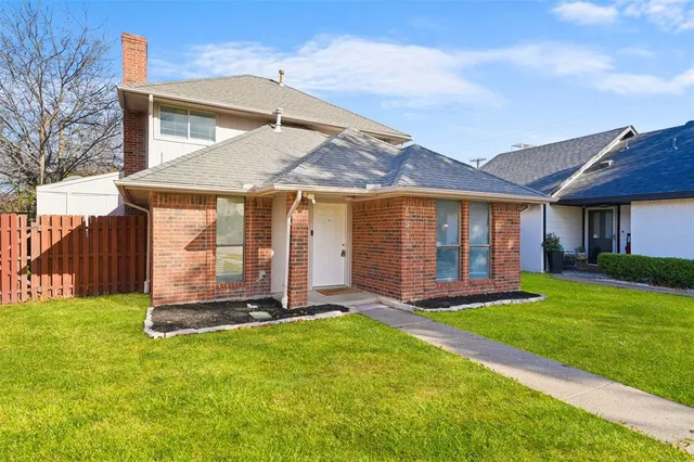a front view of a house with a yard table and chairs