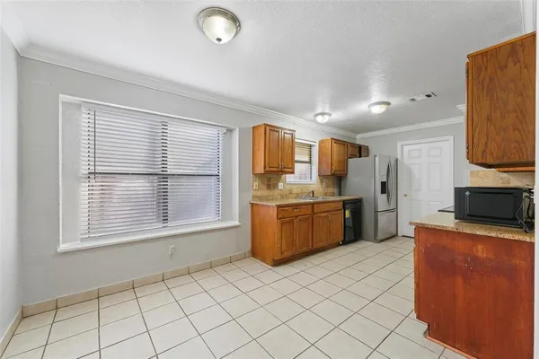 a kitchen with stainless steel appliances a stove a sink a microwave a counter top space and cabinets