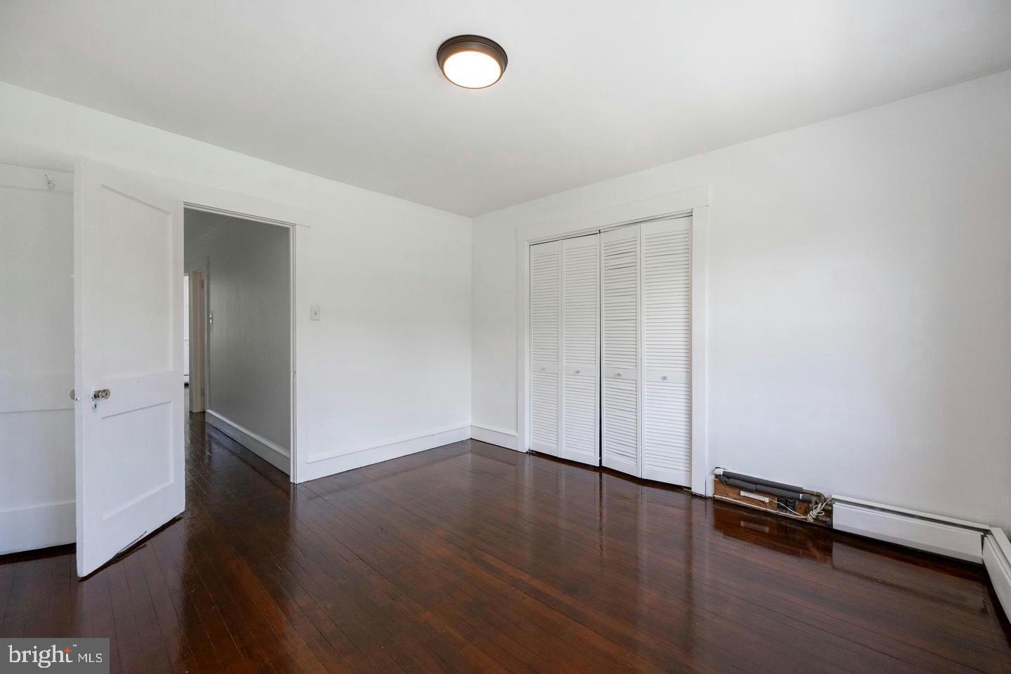 337 Stuart Avenue Downingtown, PA 19335 - Photo 15 of 19 an empty room with wooden floor and window