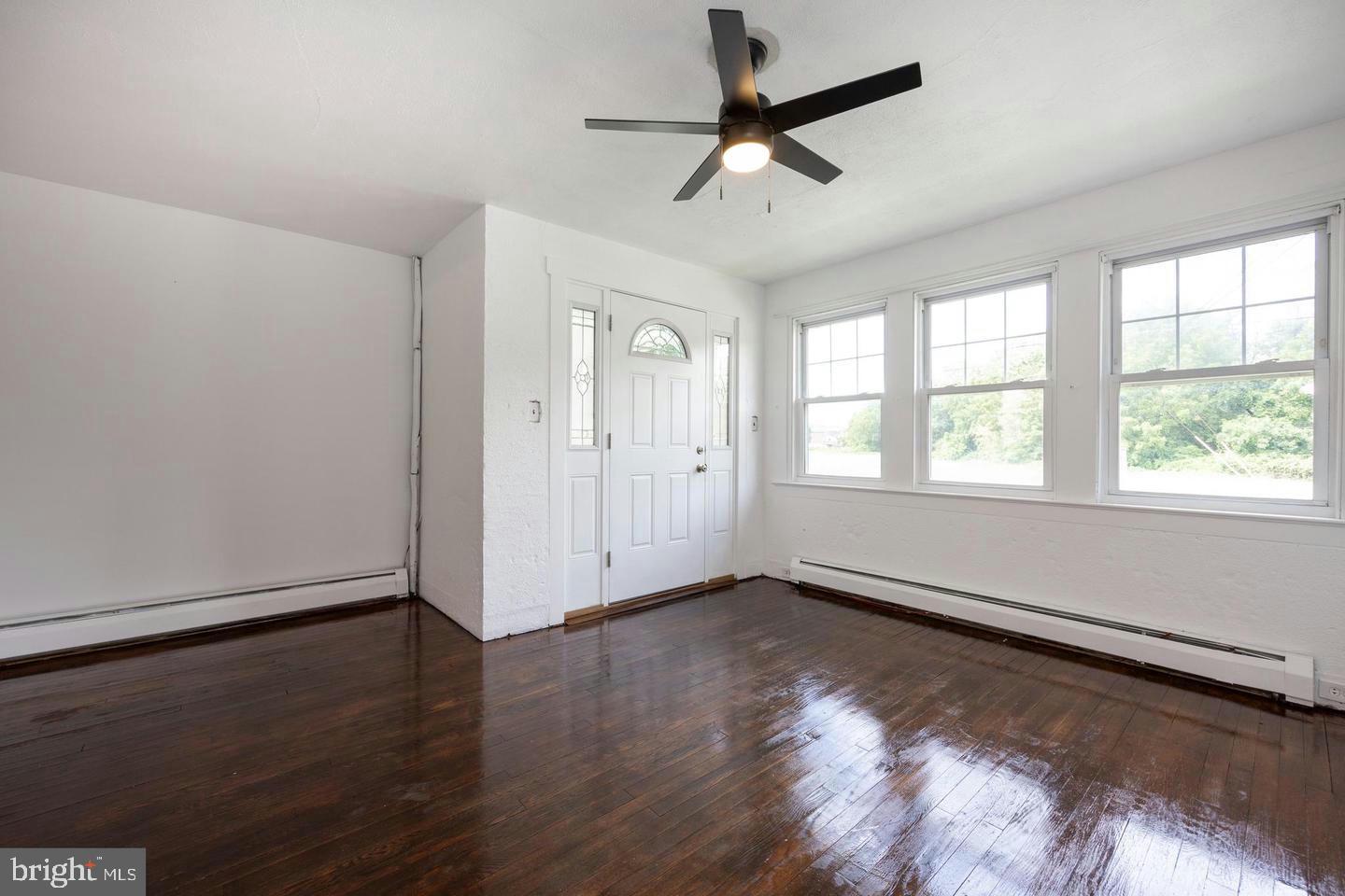 337 Stuart Avenue Downingtown, PA 19335 - Photo 3 of 19 a view of an empty room with wooden floor and a window