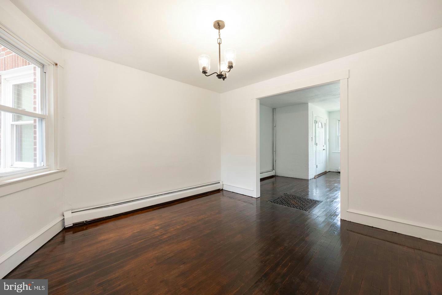 337 Stuart Avenue Downingtown, PA 19335 - Photo 6 of 19 an empty room with wooden floor chandelier and windows