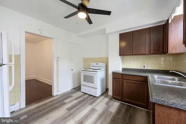 a kitchen with granite countertop a refrigerator and a sink