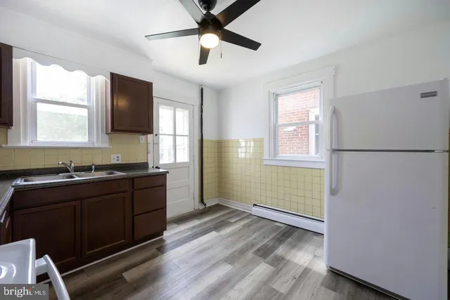 a kitchen with sink refrigerator and window
