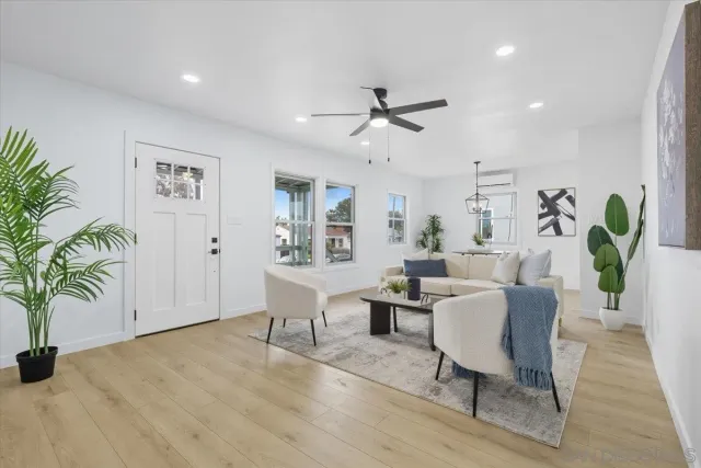 a living room with furniture and a potted plant