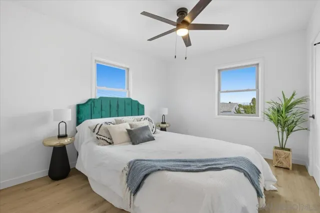 a bedroom with a bed and a potted plant