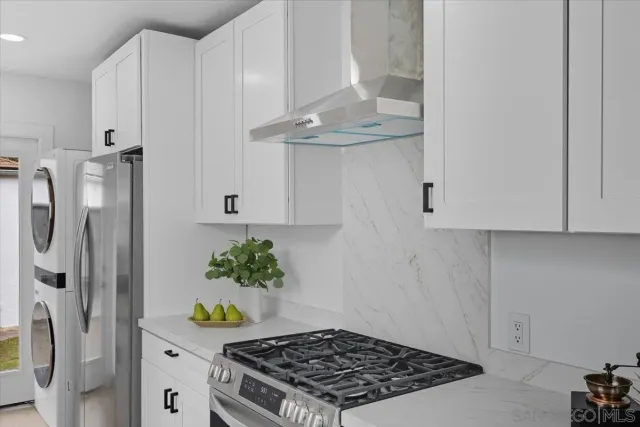 a kitchen with stainless steel appliances granite countertop a refrigerator and a stove