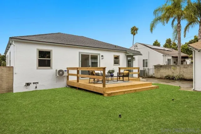 a view of a house with a yard and sitting area