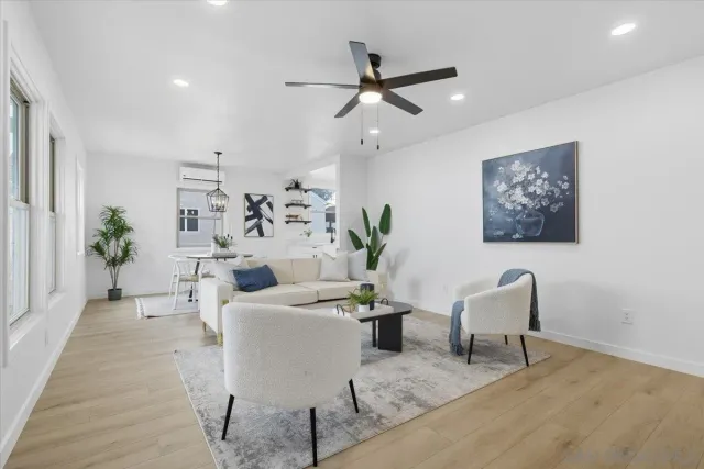 a living room with furniture and wooden floor