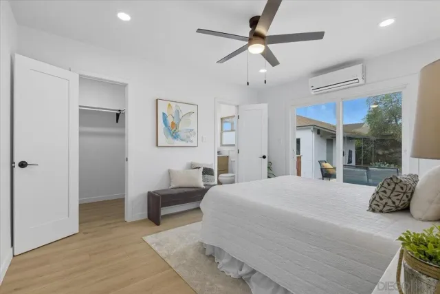 a bedroom with a large bed and a chandelier