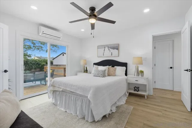 a bedroom with a large bed and a large window