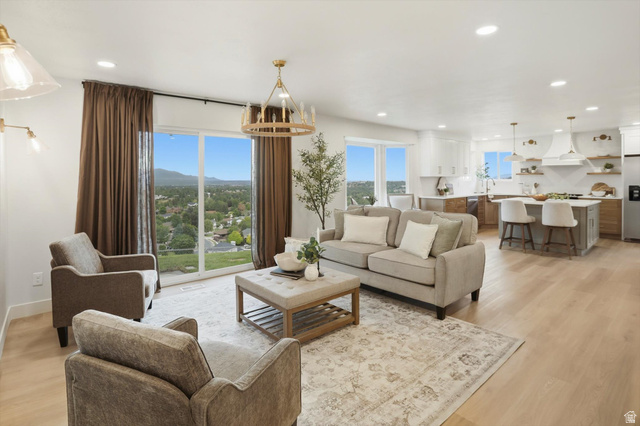 8760 Rustler Road Cottonwood Heights, UT 84093 - Photo 10 of 57 Open-concept living space featuring wood-finish flooring, recessed lighting, and a large sliding glass door
