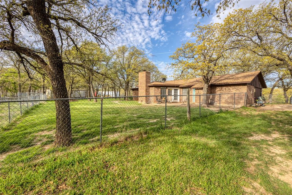 243 County Road 3851 Poolville, TX 76487 - Photo 29 of 34 a view of a house with a yard