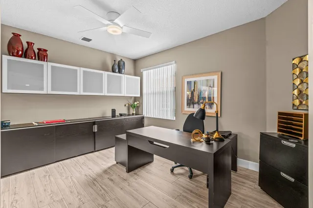 a living room with furniture and a kitchen area