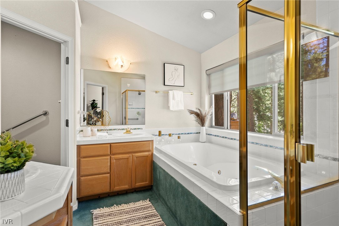 1075 Oxen Road Incline Village, NV 89451 - Photo 9 of 12 a bathroom with a tub sink and mirror