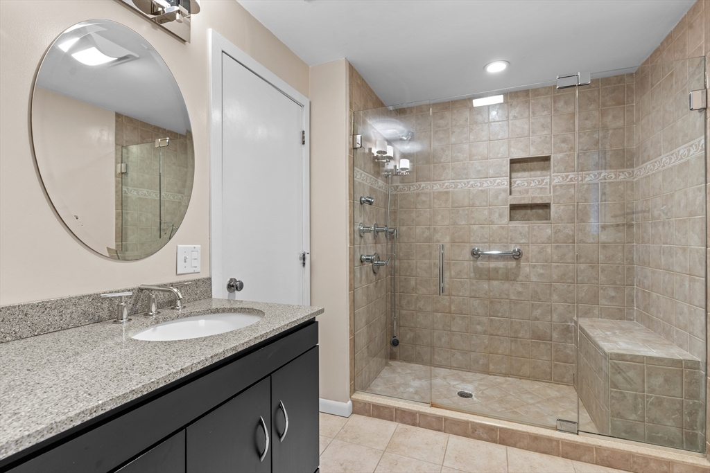 395 C Ipswich Road Boxford, MA 01921 - Photo 32 of 42 a bathroom with a granite countertop sink a shower and a mirror