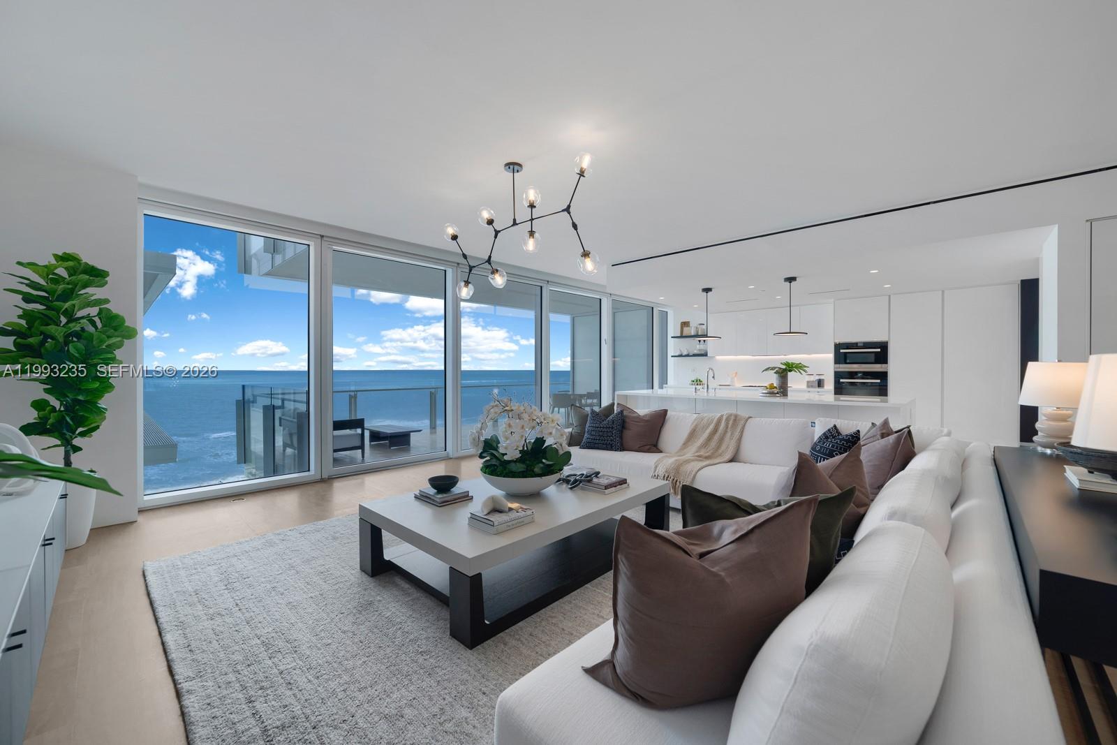 9111 Collins Avenue, Unit N717 Surfside, FL 33154 - Photo 1 of 68 a living room with furniture and a large window