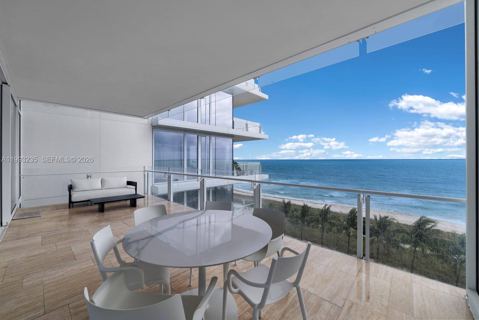 9111 Collins Avenue, Unit N717 Surfside, FL 33154 - Photo 25 of 68 a dinning table and chairs in a room