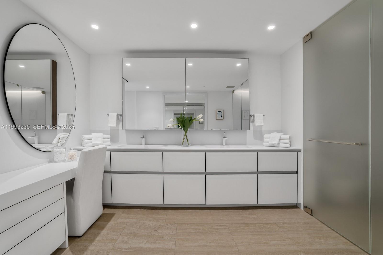 9111 Collins Avenue, Unit N717 Surfside, FL 33154 - Photo 37 of 68 a bathroom with a double vanity sink mirror and shower