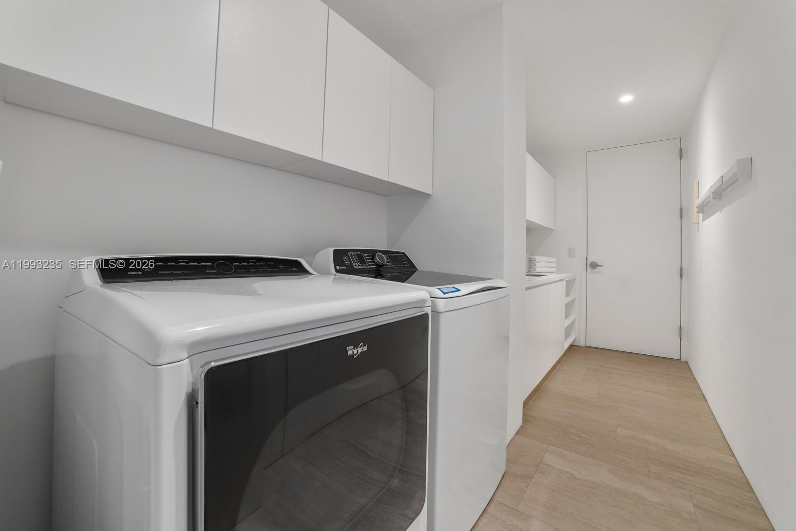 9111 Collins Avenue, Unit N717 Surfside, FL 33154 - Photo 48 of 68 a utility room with dryer and washer