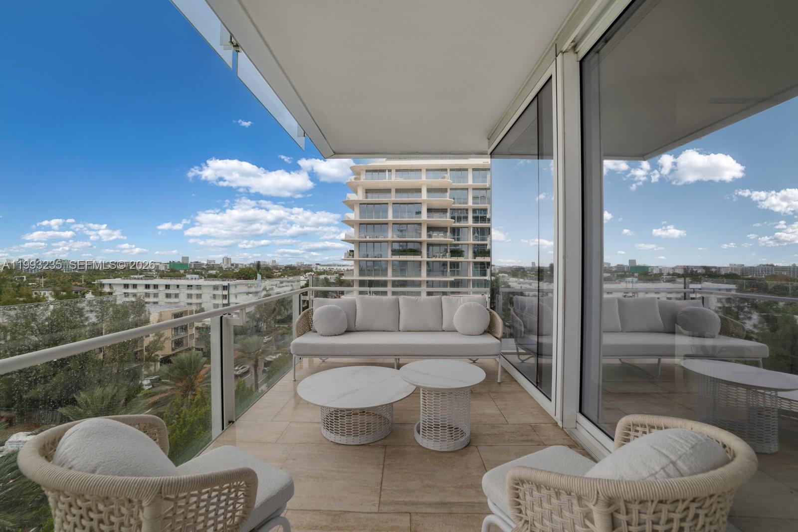 9111 Collins Avenue, Unit N717 Surfside, FL 33154 - Photo 51 of 68 a view of a balcony with couch and a potted plant
