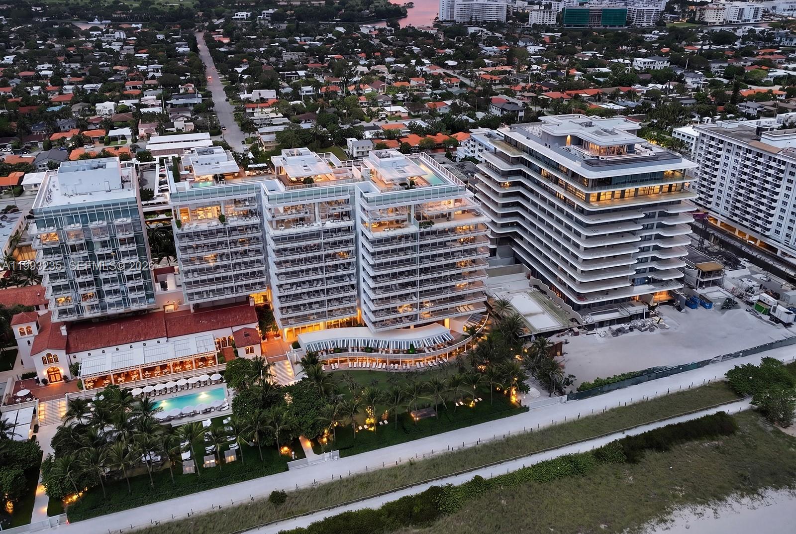 9111 Collins Avenue, Unit N717 Surfside, FL 33154 - Photo 65 of 68 an aerial view of a residential apartment building with a yard