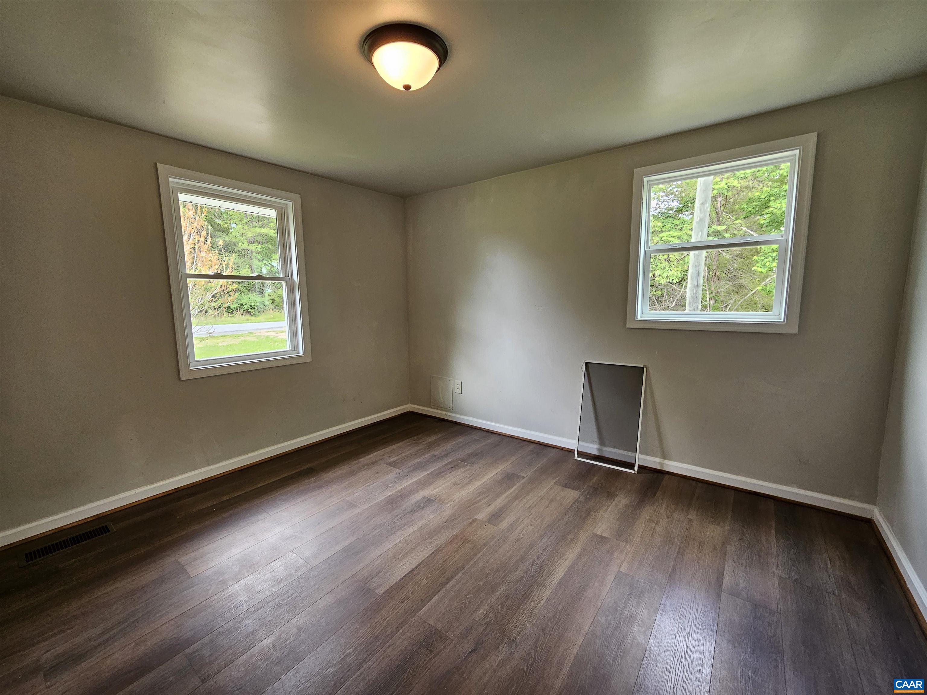 5290 Dixie Hill Road Buckingham, VA 23921 - Photo 17 of 24 an empty room with wooden floor and windows