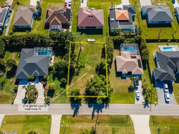 an aerial view of multiple houses with yard