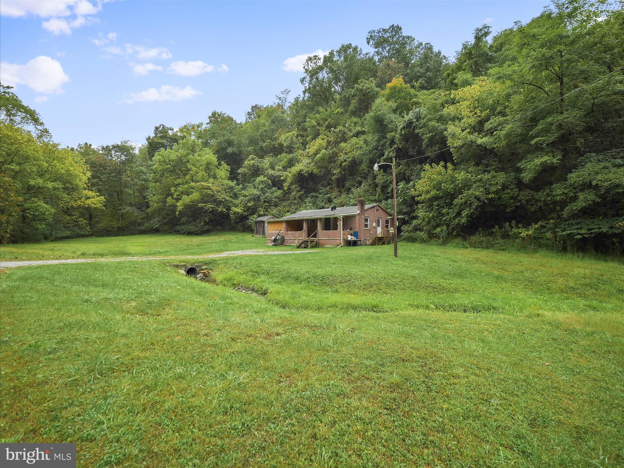 878 Co Rte 2/3 Hedgesville, WV 25427 - Photo 1 of 20 a backyard of a house with table and chairs