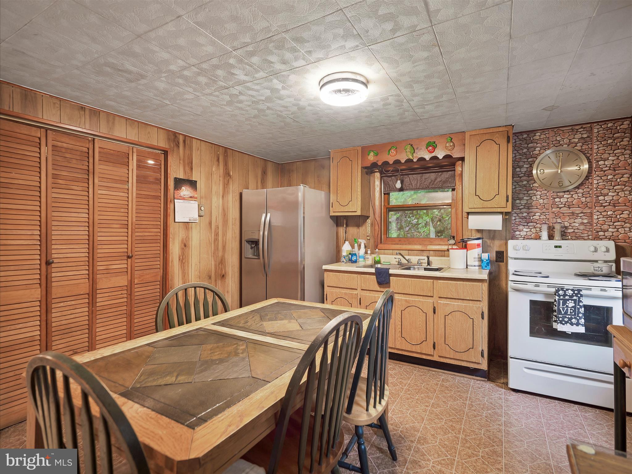 878 Co Rte 2/3 Hedgesville, WV 25427 - Photo 11 of 20 a kitchen with stainless steel appliances granite countertop a kitchen island a stove a table and a refrigerator