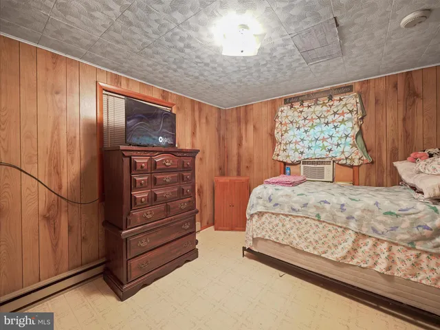 a bedroom with a bed and a dresser