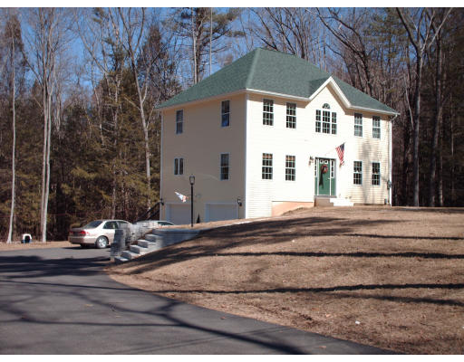 39 Leno Road Holland, MA 01521 - Photo 2 of 7 a view of a white house with large windows and a table and chairs