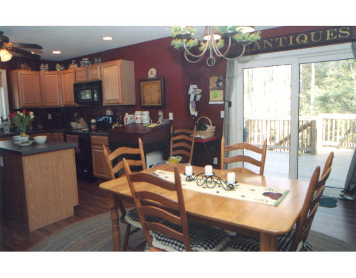 39 Leno Road Holland, MA 01521 - Photo 5 of 7 a view of a dining room with furniture a chandelier and wooden floor