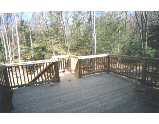 39 Leno Road Holland, MA 01521 - Photo 6 of 7 a view of a wooden deck with trees in the background