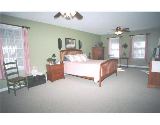 39 Leno Road Holland, MA 01521 - Photo 7 of 7 a living room with a bed furniture and a chandelier