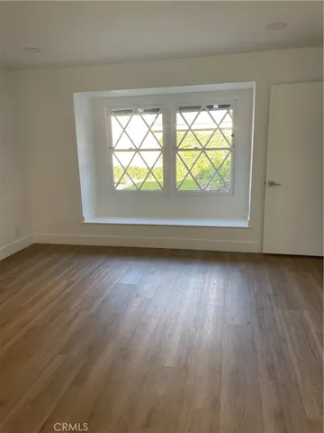 a view of room with wooden floor and window