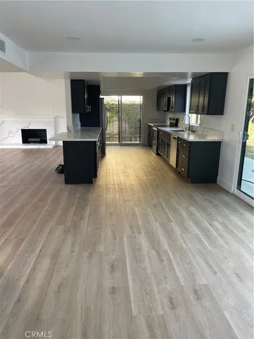 a view of kitchen with microwave refrigerator and cabinets