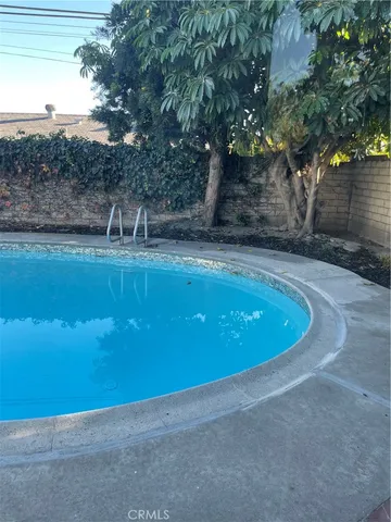 a view of a large pool and trees in the background