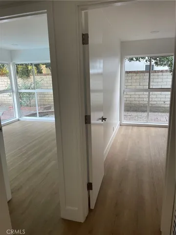 a view of a room with wooden floor and windows