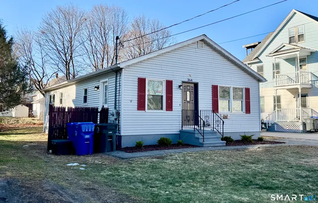 a view of a house with a yard chairs and a yard