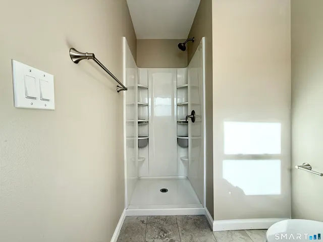 a bathroom with a glass shower door