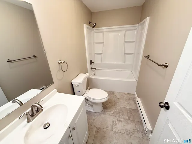 a white toilet sitting next to a bathroom sink