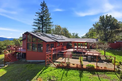 a view of a patio with table and chairs potted plants and a palm tree