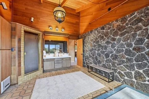 a large room with a wooden floor and a rug