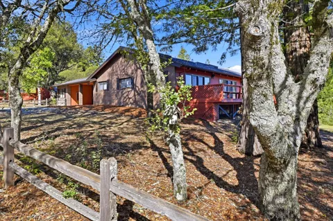 a view of a house with a tree in the background