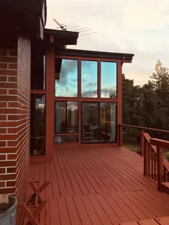a view of a house with pool and wooden floor