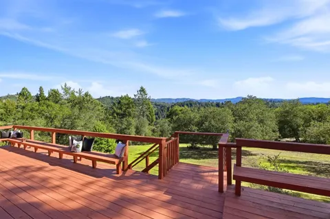 an aerial view of a house with yard and outdoor seating