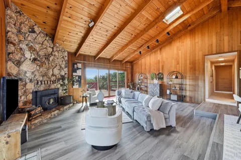 a living room with furniture a fireplace and a table