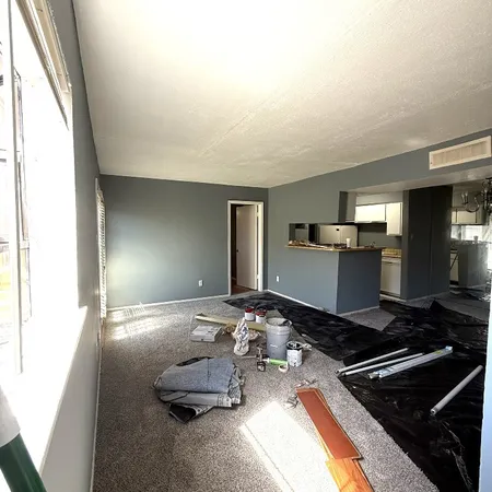 a room with gym equipment and large mirror